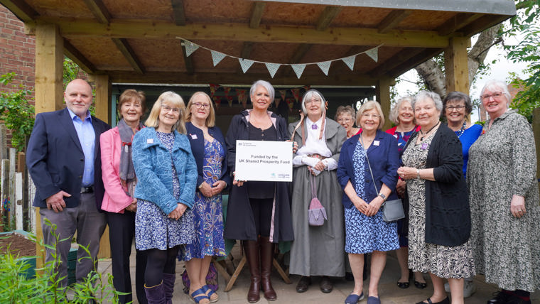 RBC Deputy Leader Cllr Abby Brennan has joined Framework Knitters Museum volunteers by the outdoor summerhouse