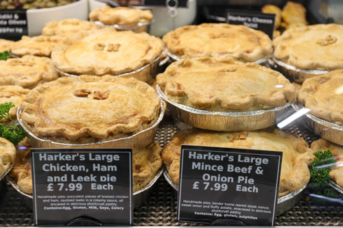 A selection of homemade pies displayed on a deli counter